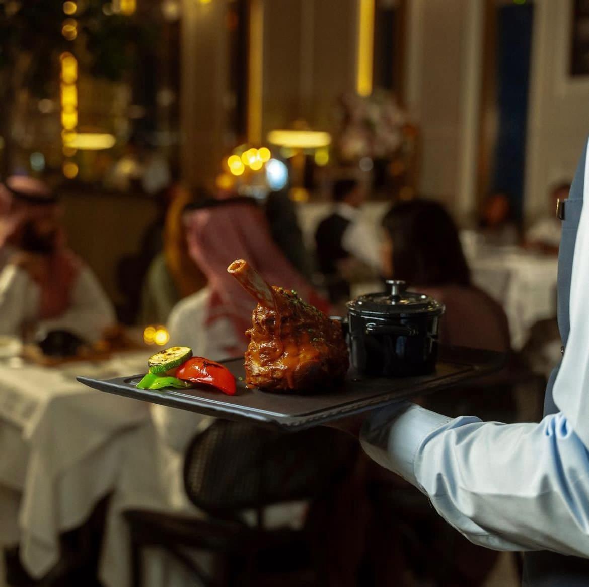 Jareed Hotel Riyadh Exterior photo A waiter serving food